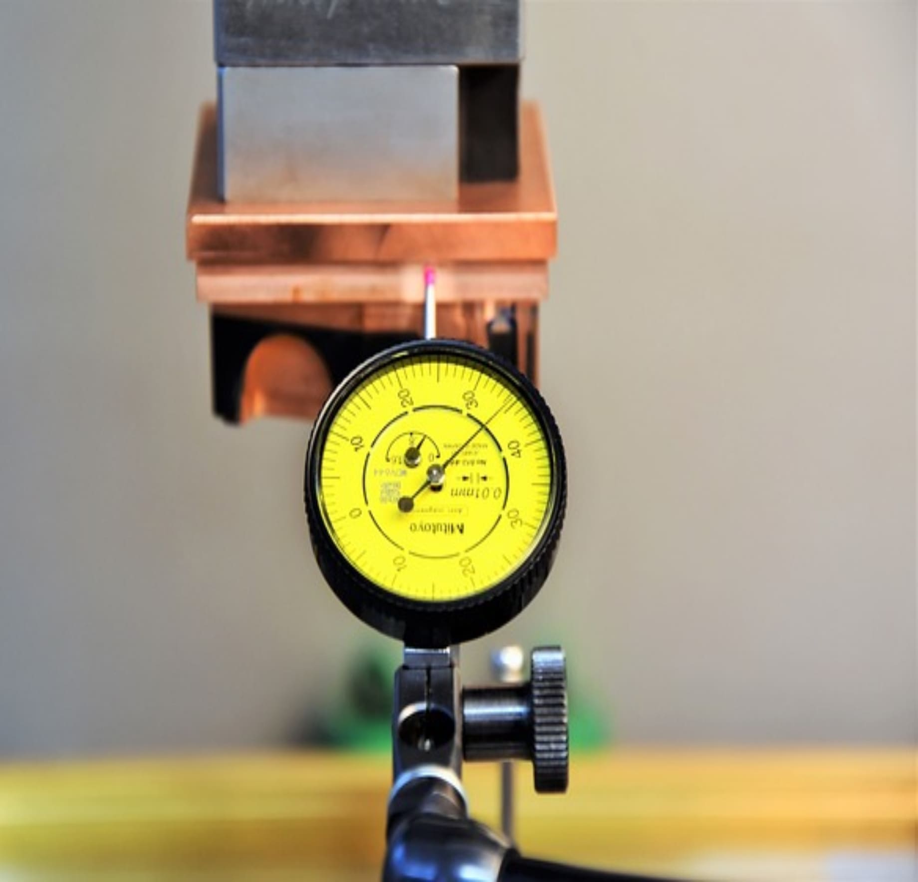 A yellow and black meter on top of a table.